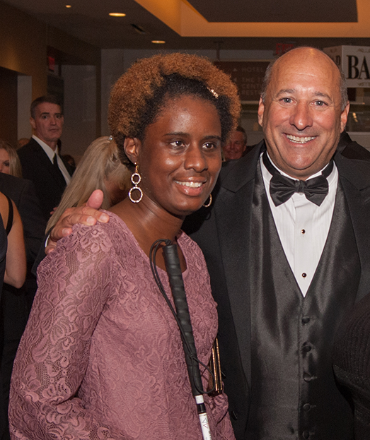 Danara in a pink dress with Michael Monteferrante at an Envision event