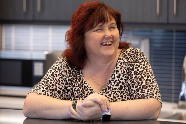 Female WIC employee laughing in the kitchen at work