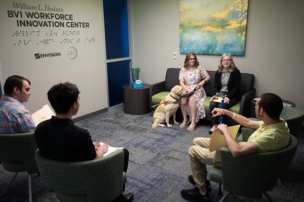 Group of people sitting around in the Envision Workforce Innovation Center lobby