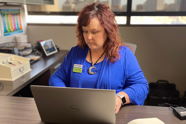 Blind woman navigating on a computer in her office