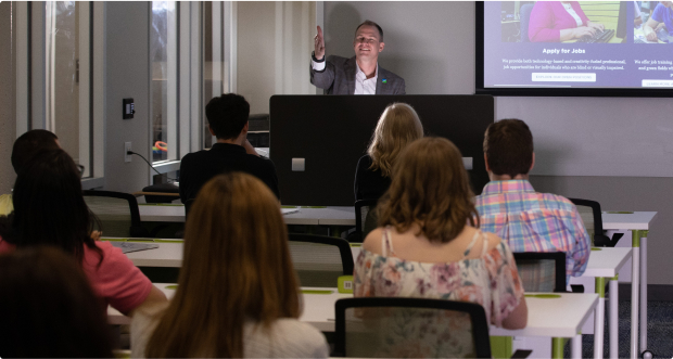 A man giving a presentation to a group of employees.